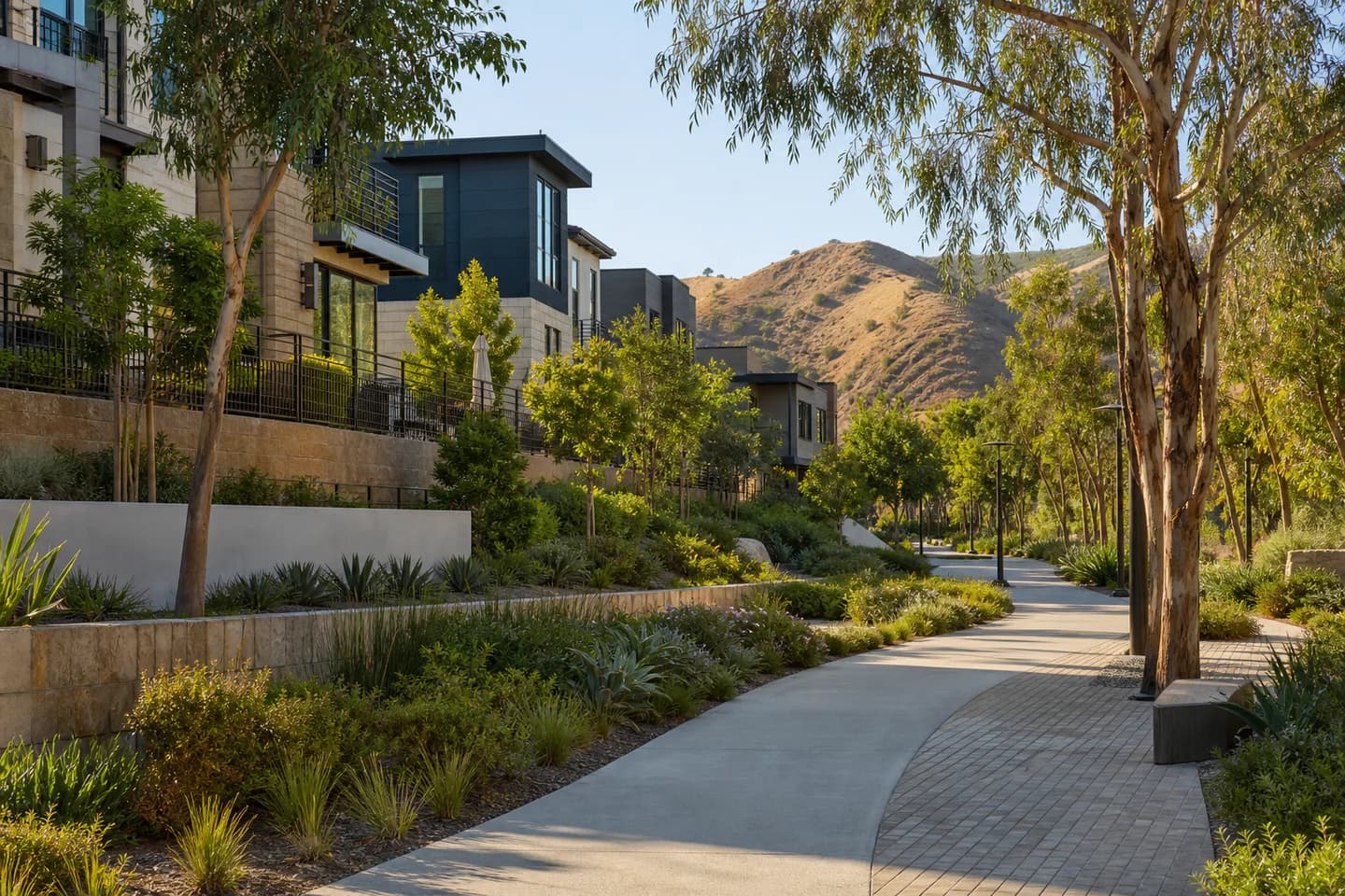 UrbanCove-generated editorial Santa Clarita and Valencia residential context with a landscaped paseo, newer homes, and foothills; not an exact community or listing